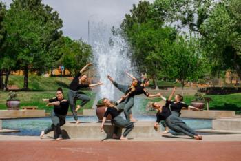 dance pose by fountain on campus