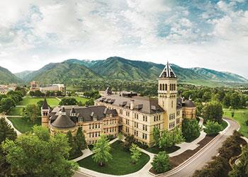 historic building surrounded by greenery and mountains