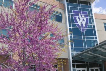 spring blossoms in front of building with logo