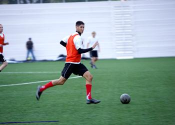 soccer player running with the ball during a game