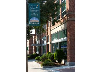 'ccv community college vermont' on banner, brick building