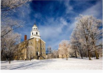 historic building in winter with snow and blue sky