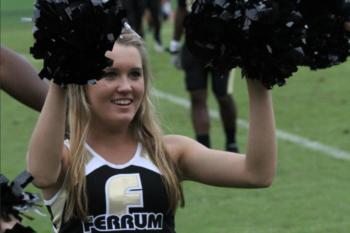 cheerleader with pom-poms at event