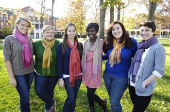 group of students smiling on campus lawn