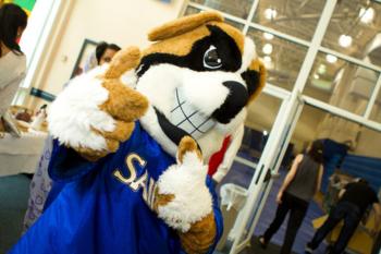 mascot giving a thumbs up at an indoor event