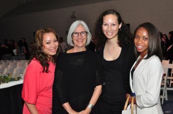 four individuals posing for a photo at an event