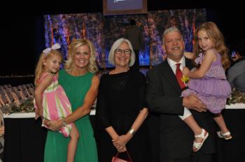 group photo with adults and children smiling