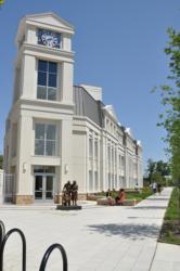 modern building with a clock tower and sculptures