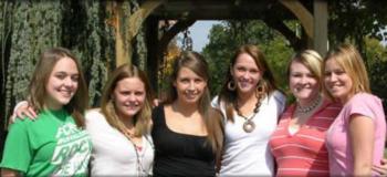 students posing under archway