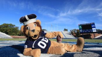 mascot lying on football field