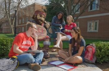 students studying outdoors with mascot