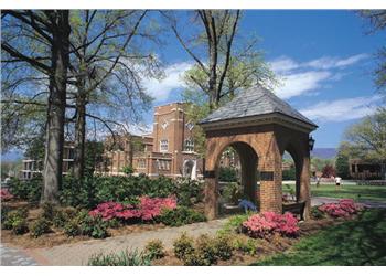 brick building with gazebo and flowering plants