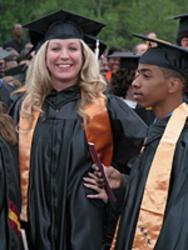 two graduates embracing