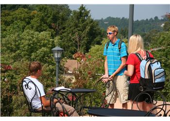 students chatting at an outdoor campus setting