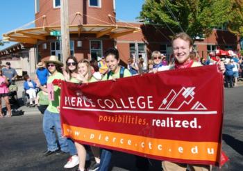 group holding 'pierce college' banner