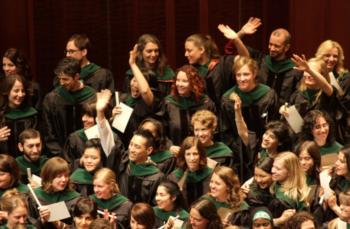 group of graduates smiling and waving