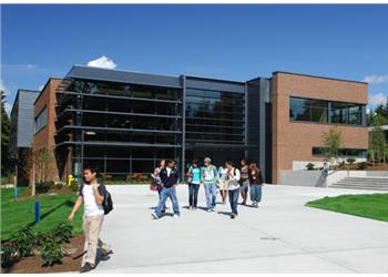 students walking in front of modern campus building