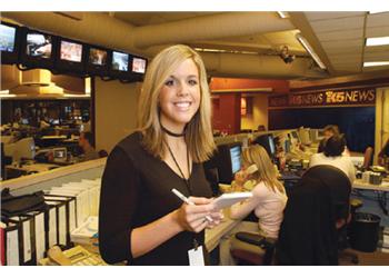 reporter with notepad in newsroom