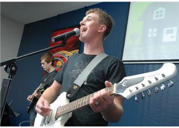 musician playing electric guitar on stage