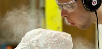 student sculpting with dust particles in air