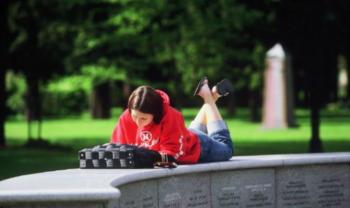 student studying on campus outdoor seating