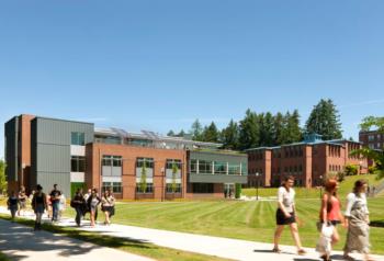 students walking outside modern campus building