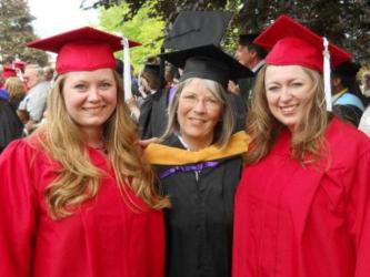 three graduates smiling