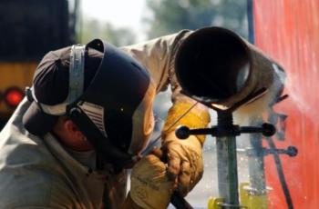 person welding with protective gear