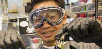 student with lab goggles and test tube