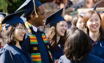 graduates laughing together