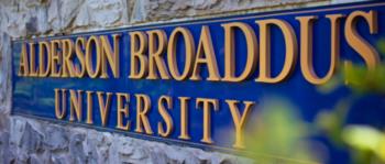 sign with 'alderson broaddus university' on stone wall