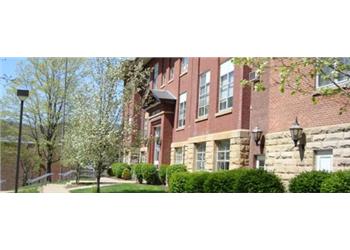 brick building with trees in bloom