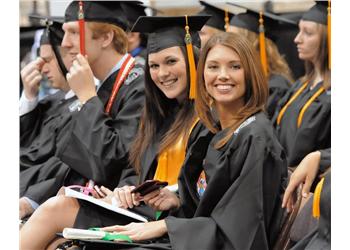 graduates smiling at commencement ceremony