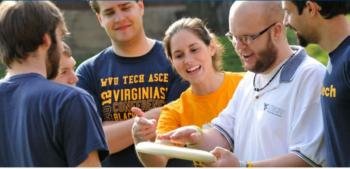 students studying outdoors with 'wvu tech' shirts