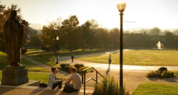 campus scene with statue and students