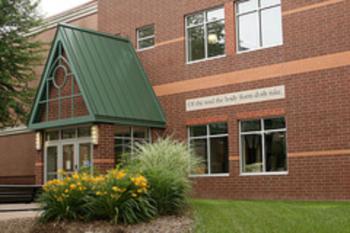 brick building with green roof and windows