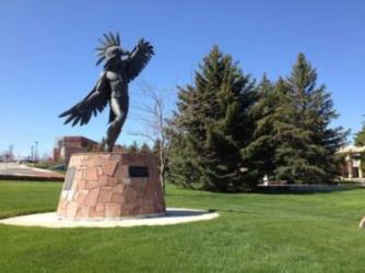 thunderbird statue on green grass