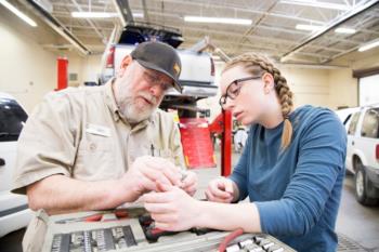 student and instructor working on automotive repair