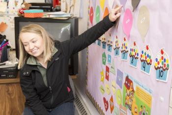 student teaching with educational wall decoration