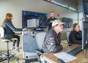 students analyzing data on multiple computer monitors