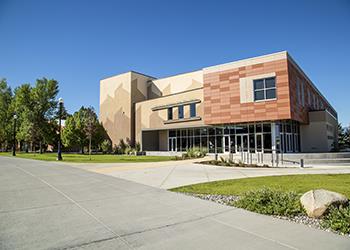 sunlit modern campus building with clear skies