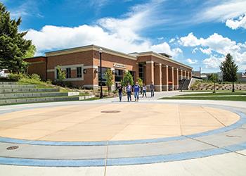 students socializing in front of campus building