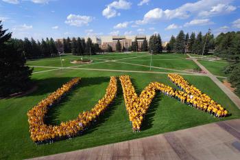 students forming the letters UW on a lawn