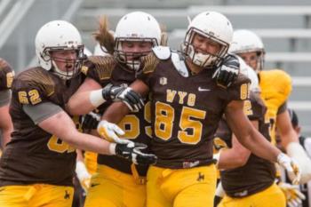 wyoming football players celebrating on the field