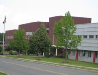 campus building with trees and flag