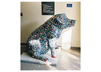 sculpture of a pig made with colorful bottle caps