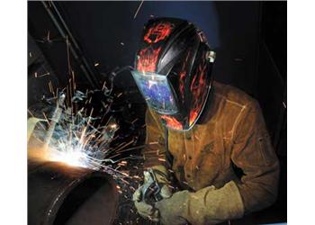 person welding with sparks flying