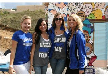 smiling students wearing school pride shirts