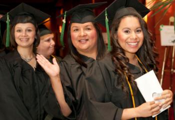 graduates smiling in cap and gown