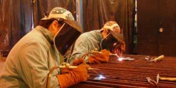 two people welding in protective gear